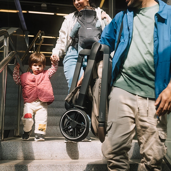 Joolz Hub² Compact Stroller Lifestyle Folded Over the Shoulder Carry