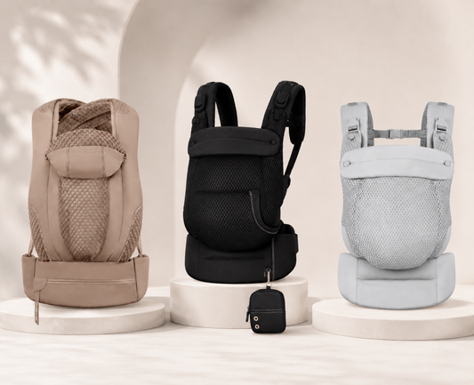 Three baby carriers in beige, black, and light gray are displayed side-by-side on individual white pedestals.