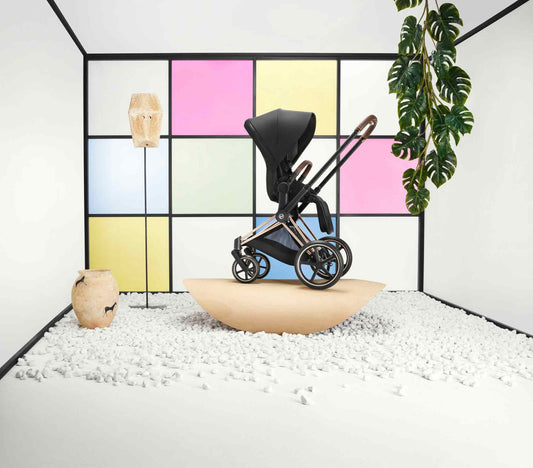 CYBEX Priam stroller in black with rose gold frame in a modern styled room