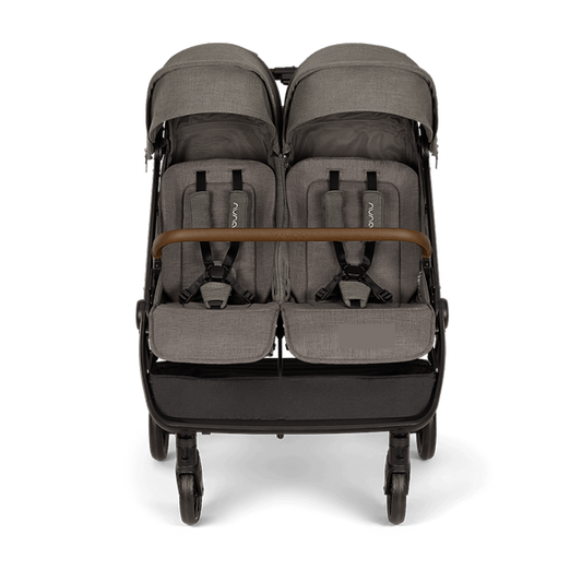 [Granite] Front view of a grey side-by-side double stroller with sun canopies, safety harnesses, and a brown bumper bar