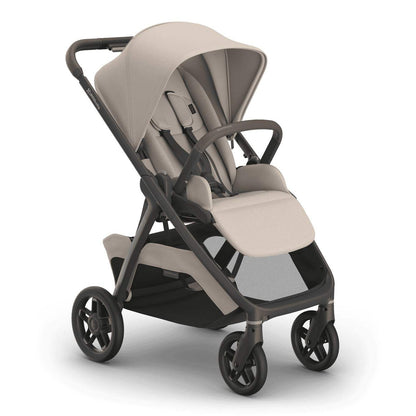 
A beige-and-grey four-wheel baby stroller with an open canopy and storage basket, shown from a three-quarter angle on a white background.