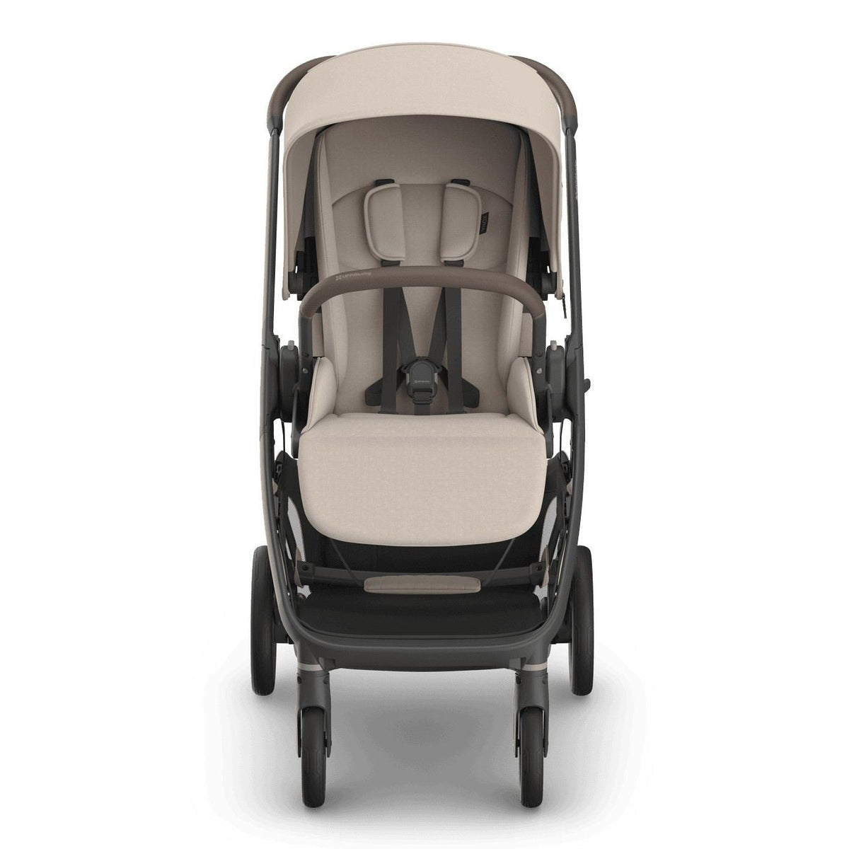 
Front view of a beige baby stroller with a grey frame, sun canopy, and safety harness, isolated on a white background.