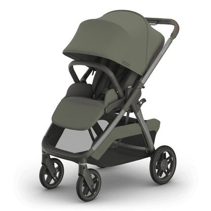 
An olive green baby stroller with a grey frame, sun canopy, and lower storage basket, isolated on a white background.