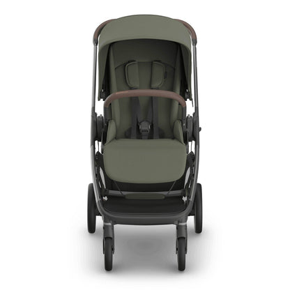 
Front view of an olive green baby stroller with a grey frame, sun canopy, and safety harness, isolated on a white background.