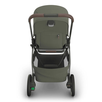 
Rear view of an olive green baby stroller with a grey frame, handle, and storage basket, isolated on a white background.