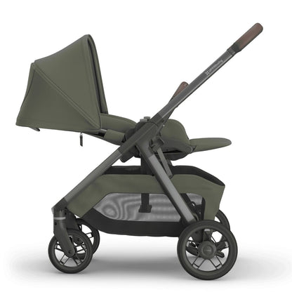 
Side profile of a reclined olive green parent-facing baby stroller with a grey frame, isolated on a white background.