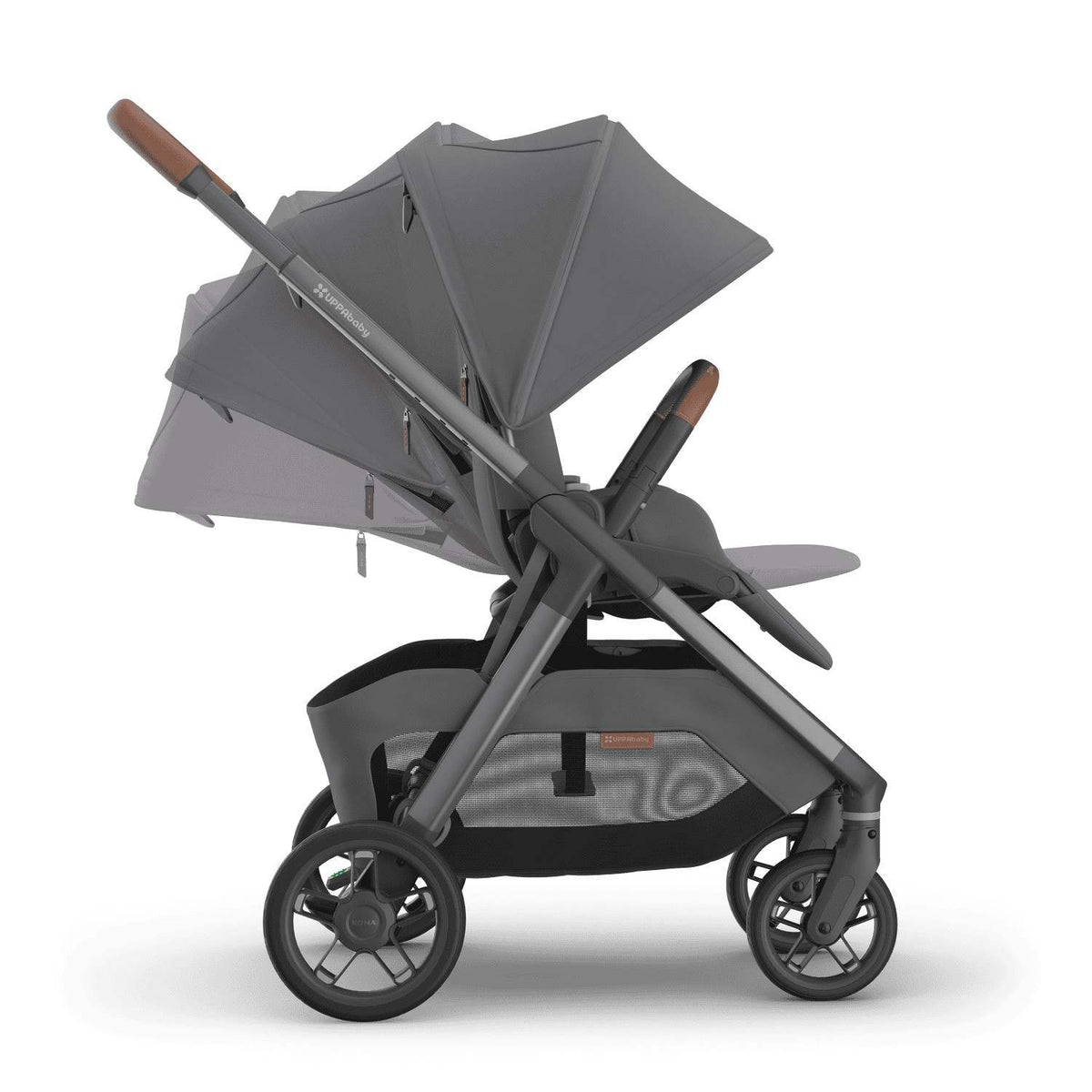 
Side profile of a grey parent-facing baby stroller demonstrating recline positions, featuring brown leather handle grips and an extended sun canopy, isolated on a white background.