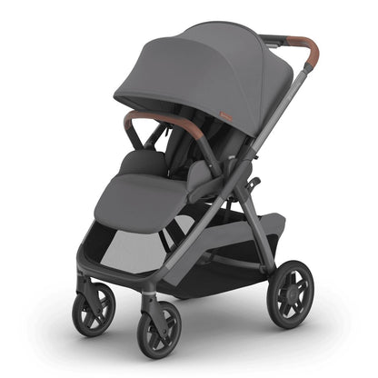 
Three-quarter front view of a grey forward-facing baby stroller with brown leather handle grips and a storage basket, isolated on a white background.