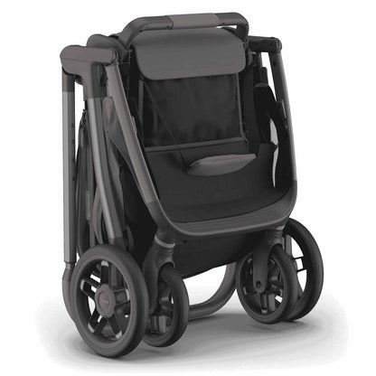 
Three-quarter front view of a folded grey baby stroller standing upright, isolated on a white background.