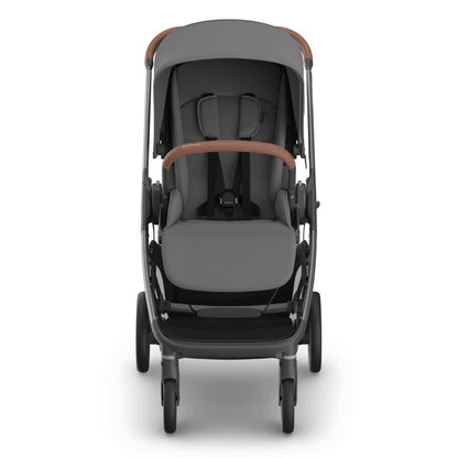 
Front view of a grey forward-facing baby stroller with brown leather handle grips, isolated on a white background.