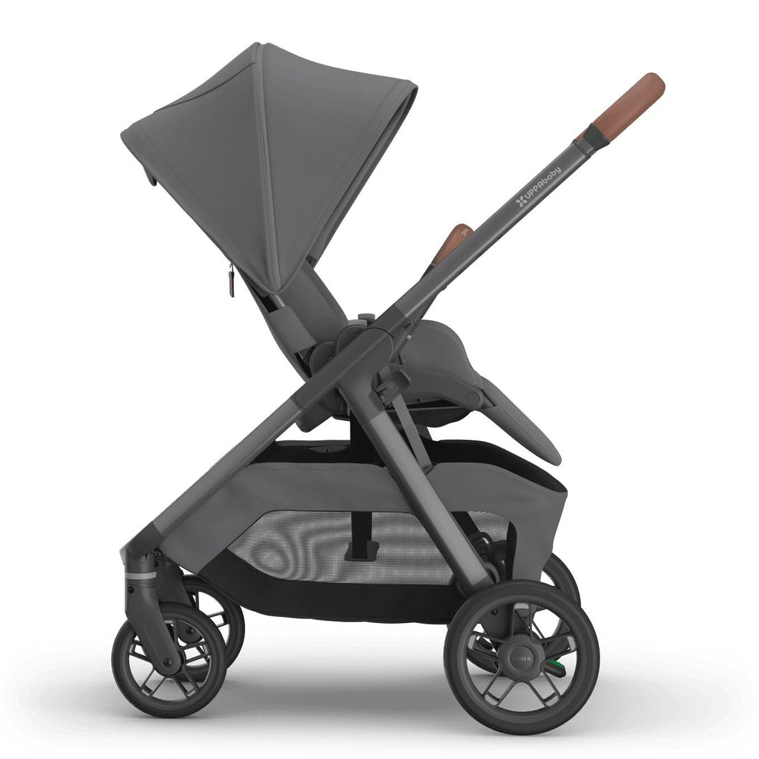 
Side profile of a semi-reclined grey parent-facing baby stroller with an extended sun canopy and brown leather handle grips, isolated on a white background.