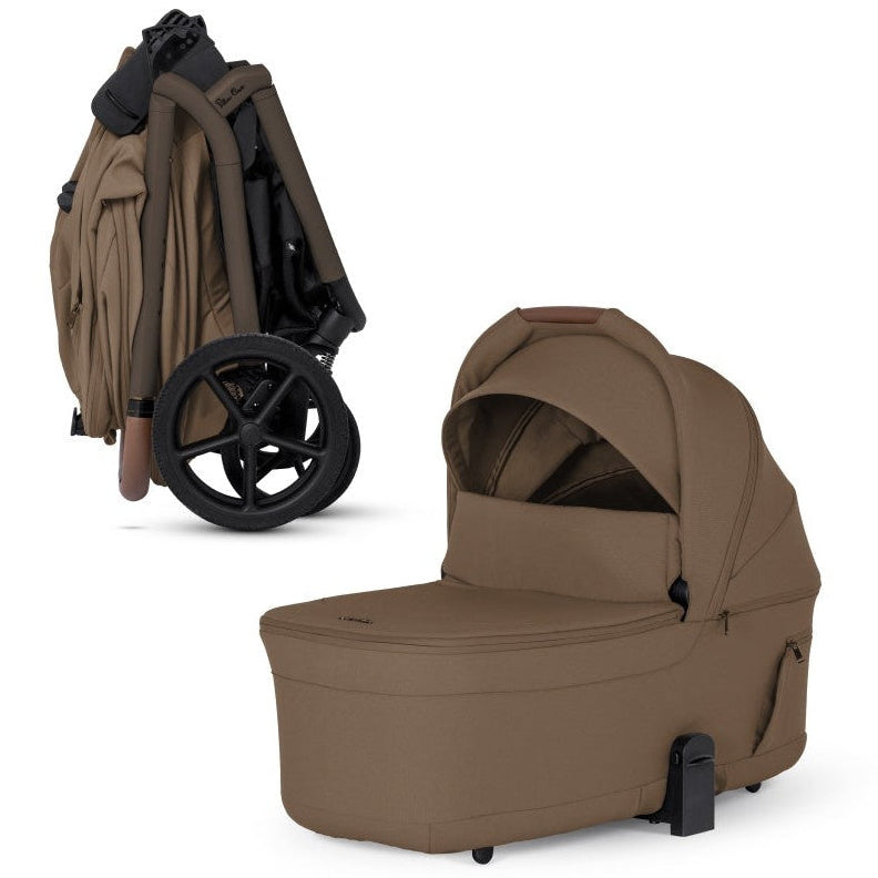 A beige stroller shown compactly folded alongside its matching standalone beige bassinet.