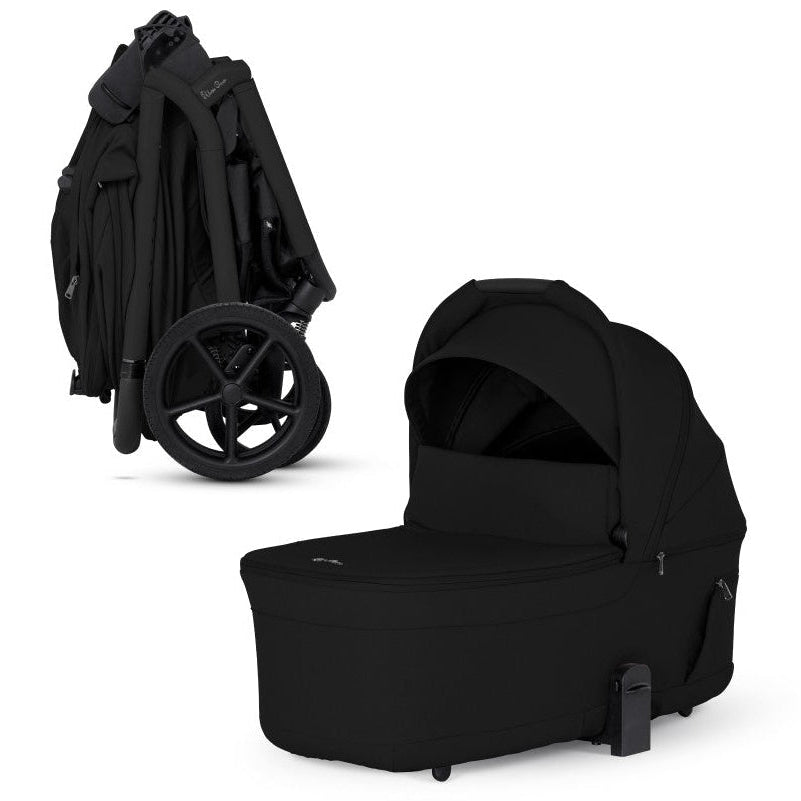 An all-black stroller shown compactly folded alongside its matching standalone black bassinet.