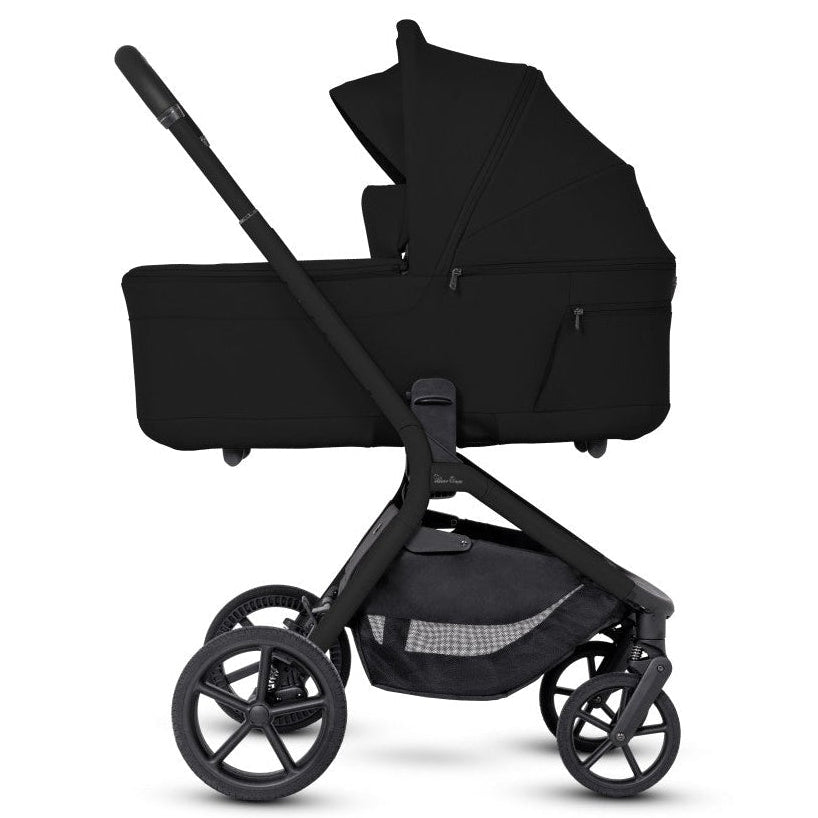 Side profile of an all-black stroller frame with a black bassinet attached.