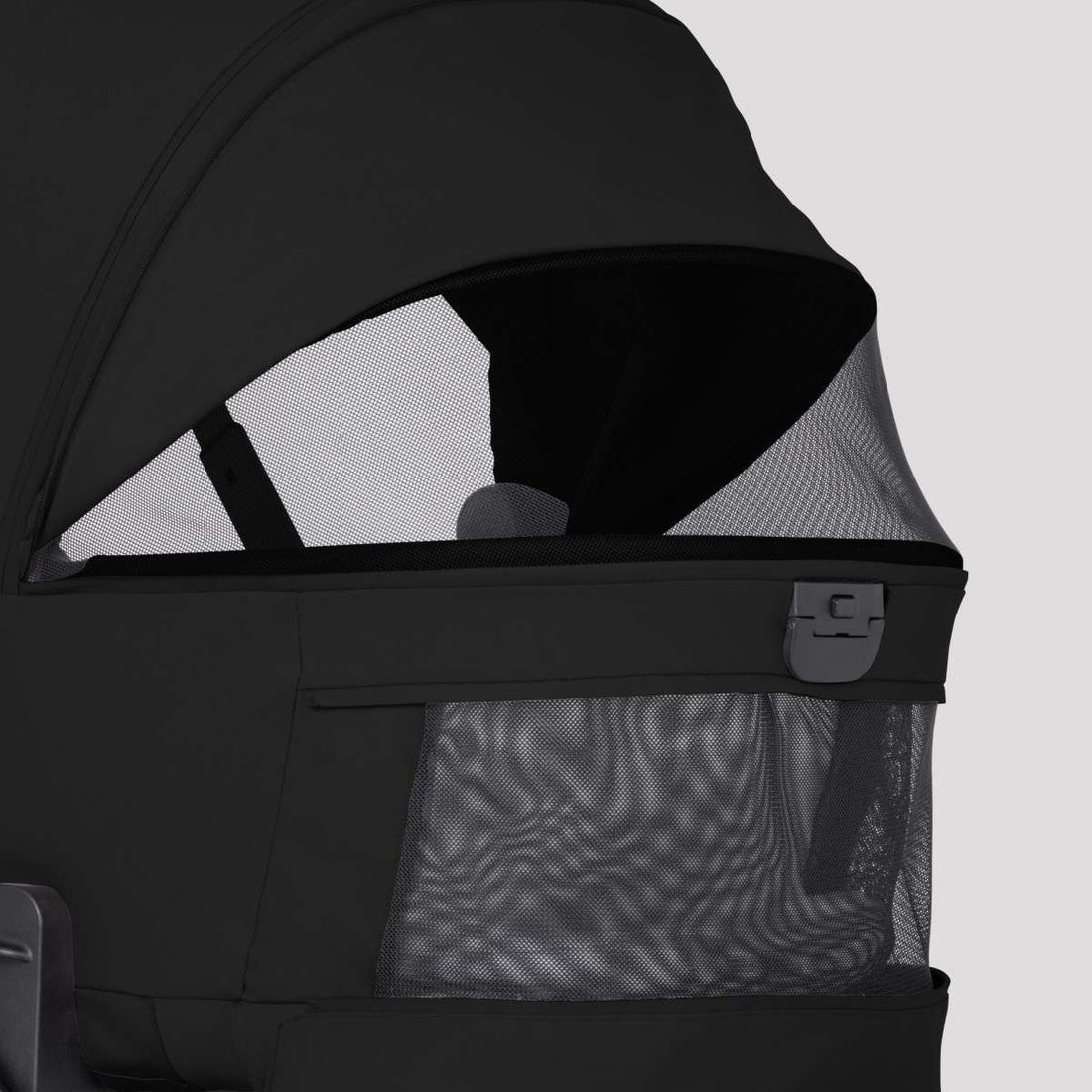 Close-up of a black stroller bassinet featuring extended mesh ventilation panels on the side and canopy.