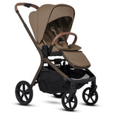 A beige modern stroller with brown leather accents shown fully open from a three-quarters perspective.