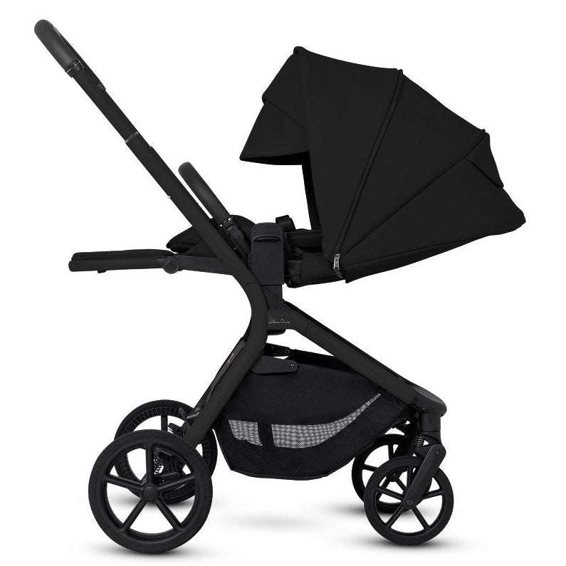 Side profile of an all-black stroller with its seat in a fully reclined position and the canopy extended.