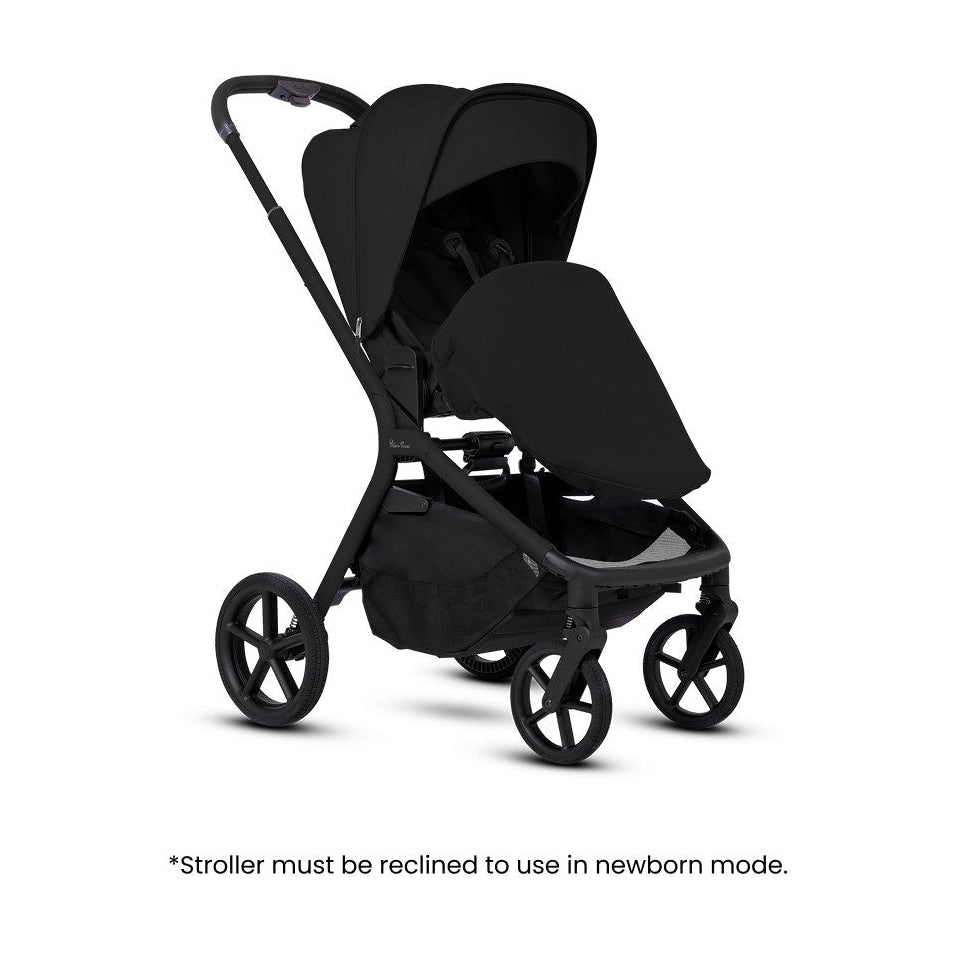 An open all-black stroller fitted with a newborn apron cover.