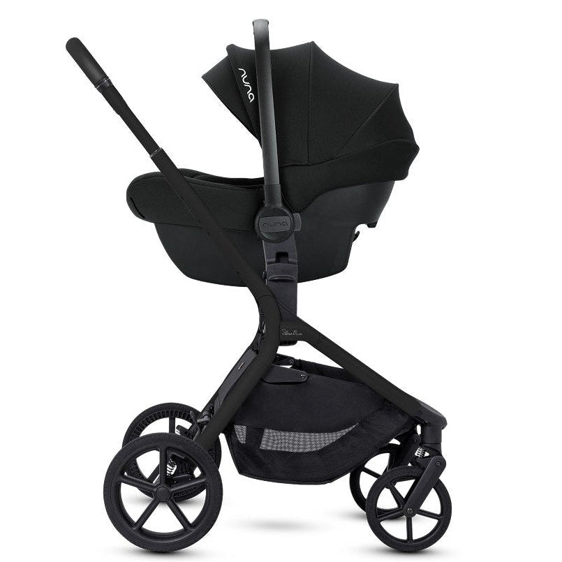 Side profile of an all-black stroller frame with a black infant car seat attached.