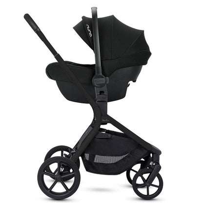 Side profile of an all-black stroller frame with a black infant car seat attached.