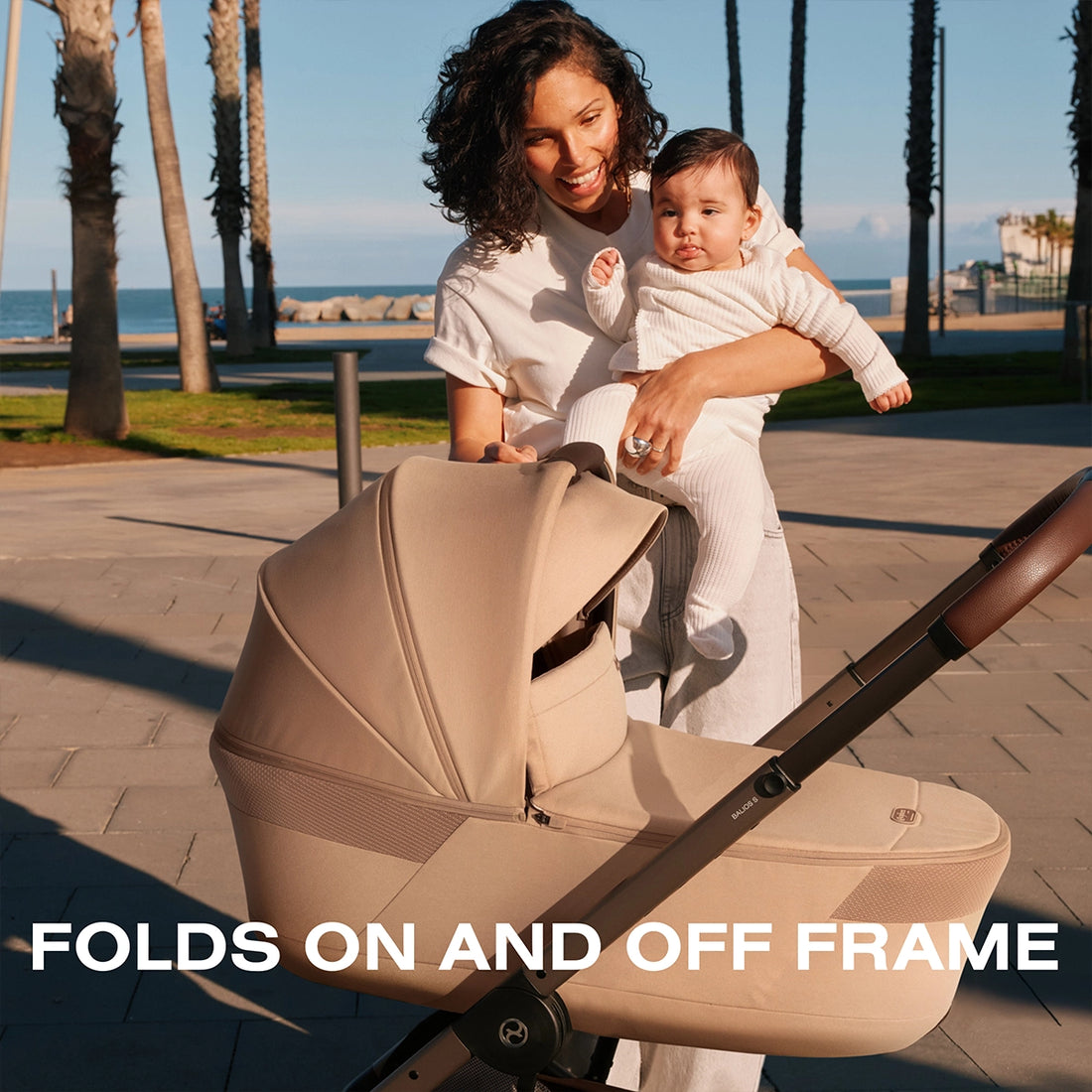 Close up of Mom and Baby Showing the Cybex Balios Cot that can be folded on and off the frame