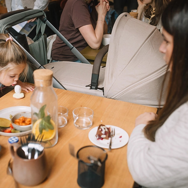 Joolz Hub² Compact Stroller with Carry Cot in Sandy Taupe Lifestyle Dining Out