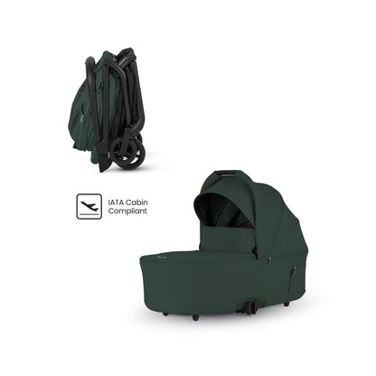 Dark green travel stroller shown compactly folded alongside a matching dark green bassinet and an "IATA Cabin Compliant" logo.