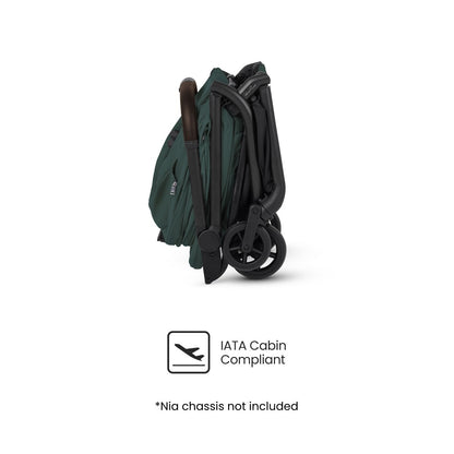Side profile of a dark green, compactly folded travel stroller displayed above an "IATA Cabin Compliant" logo.