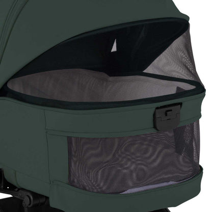A close-up view of an olive green stroller bassinet showing ventilated mesh panels on the canopy and base.