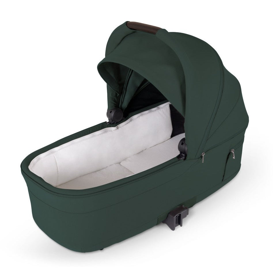 An olive green standalone stroller bassinet with an open canopy and white padded interior lining.
