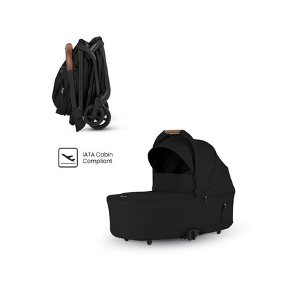 Black travel stroller shown compactly folded alongside a matching black bassinet and an "IATA Cabin Compliant" logo.