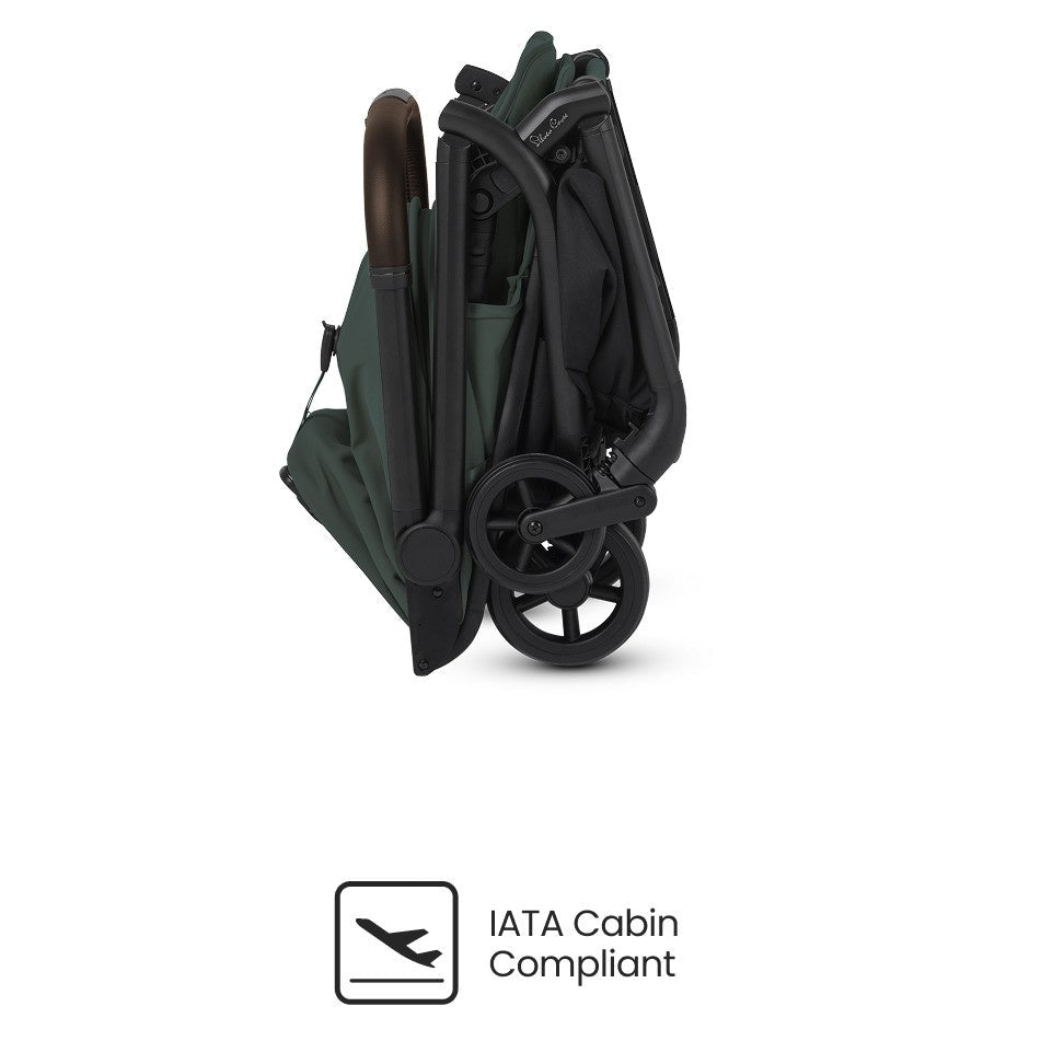 A side view of a compactly folded olive green stroller featuring an "IATA Cabin Compliant" icon.