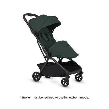 Dark green travel stroller shown in a reclined position with a footmuff, displayed above text noting it must be reclined for newborn mode.