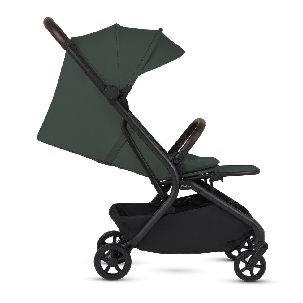 A side profile view of an open olive green stroller with a brown handlebar and bumper bar.