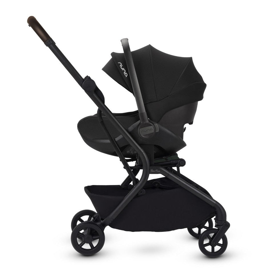 A side view of a stroller frame configured as a travel system with an attached black infant car seat.