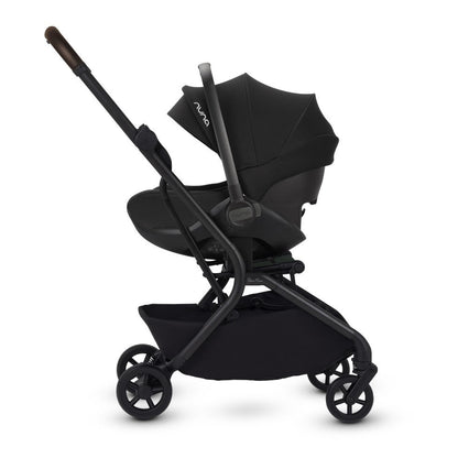 A side view of a stroller frame configured as a travel system with an attached black infant car seat.