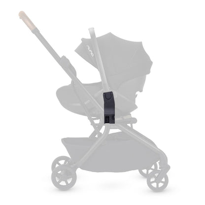 Side profile of a black car seat adapter highlighted in full contrast on a faded stroller frame.