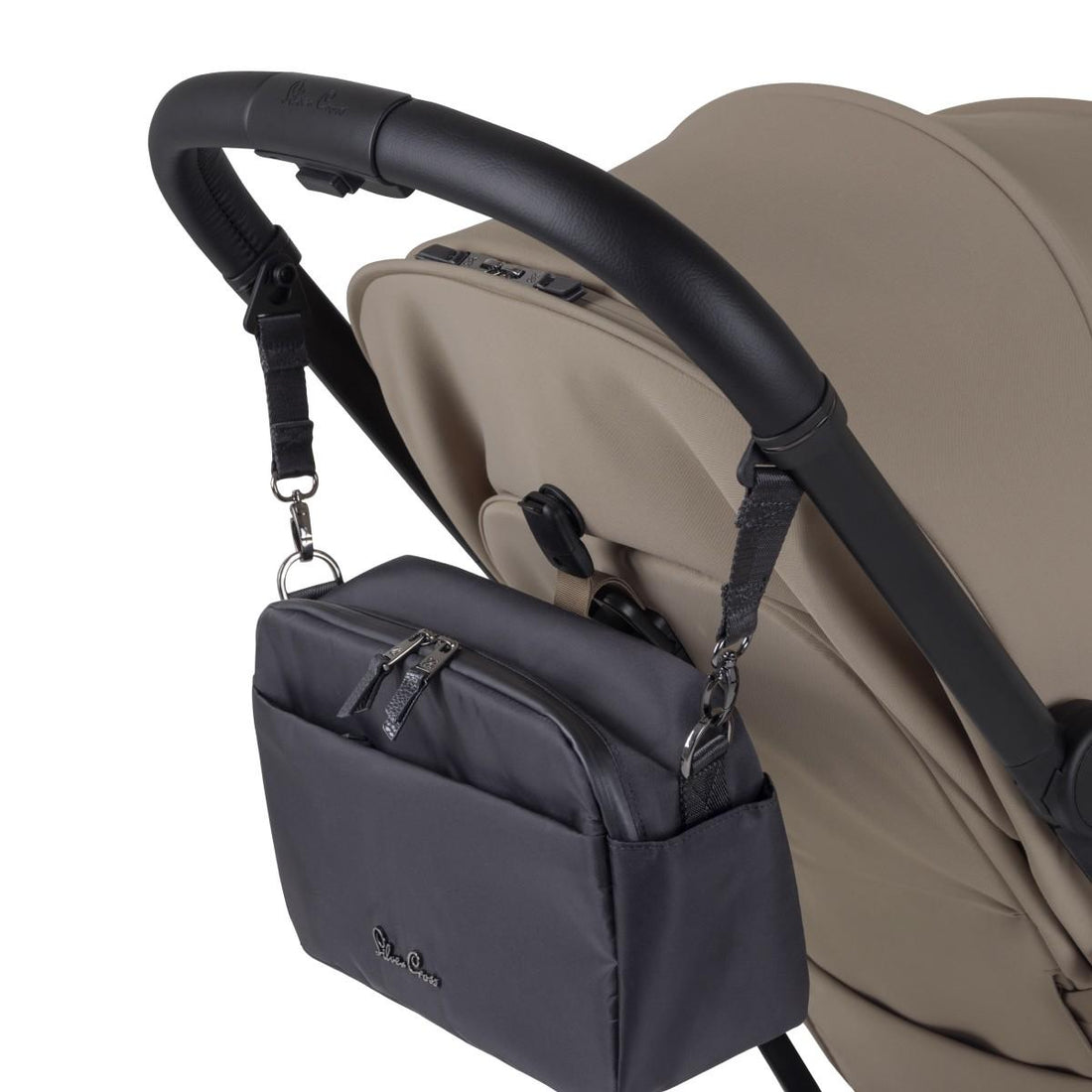 A black fabric stroller organizer bag hanging from a black leather handlebar by adjustable straps.