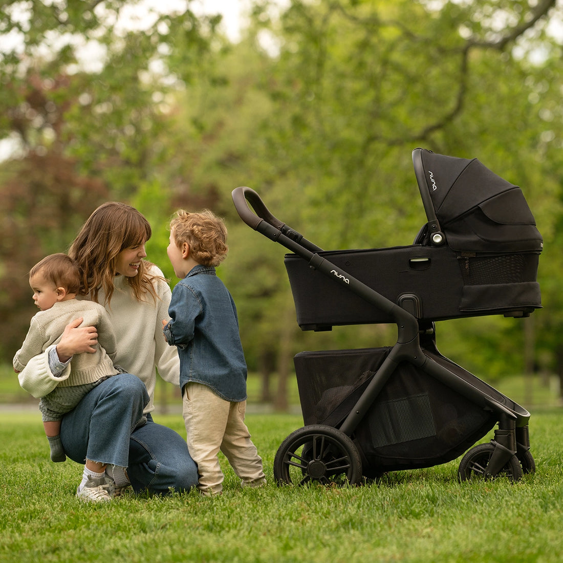 Nuna Demi Bassinet on Nuna Demi Icon Stroller with Mom and two kids lifestyle image