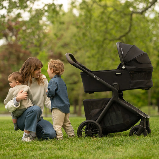 Nuna Demi Bassinet on Nuna Demi Icon Stroller with Mom and two kids lifestyle image