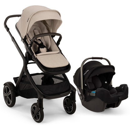 
A stroller and infant car seat travel system shown on a clean white background. The stroller has a light beige fabric seat and canopy with a black frame and wheels, and is shown next to a matching black infant car seat.