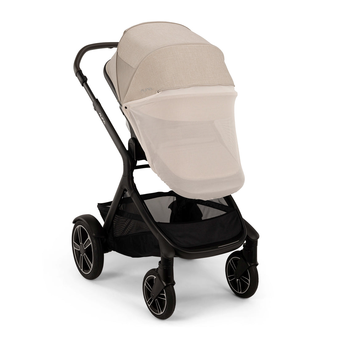 
A stroller with a black frame and a light beige mesh canopy and footmuff, shown from a three-quarters angle on a white background.
