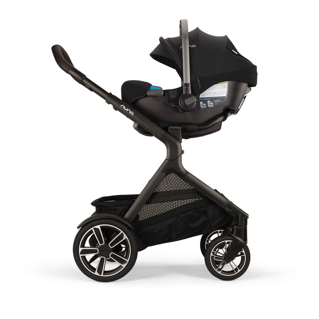 
A black and dark gray stroller with an attached infant car seat and canopy, shown from a side profile on a clean white background. The stroller features a large storage basket underneath and multi-spoke wheels.