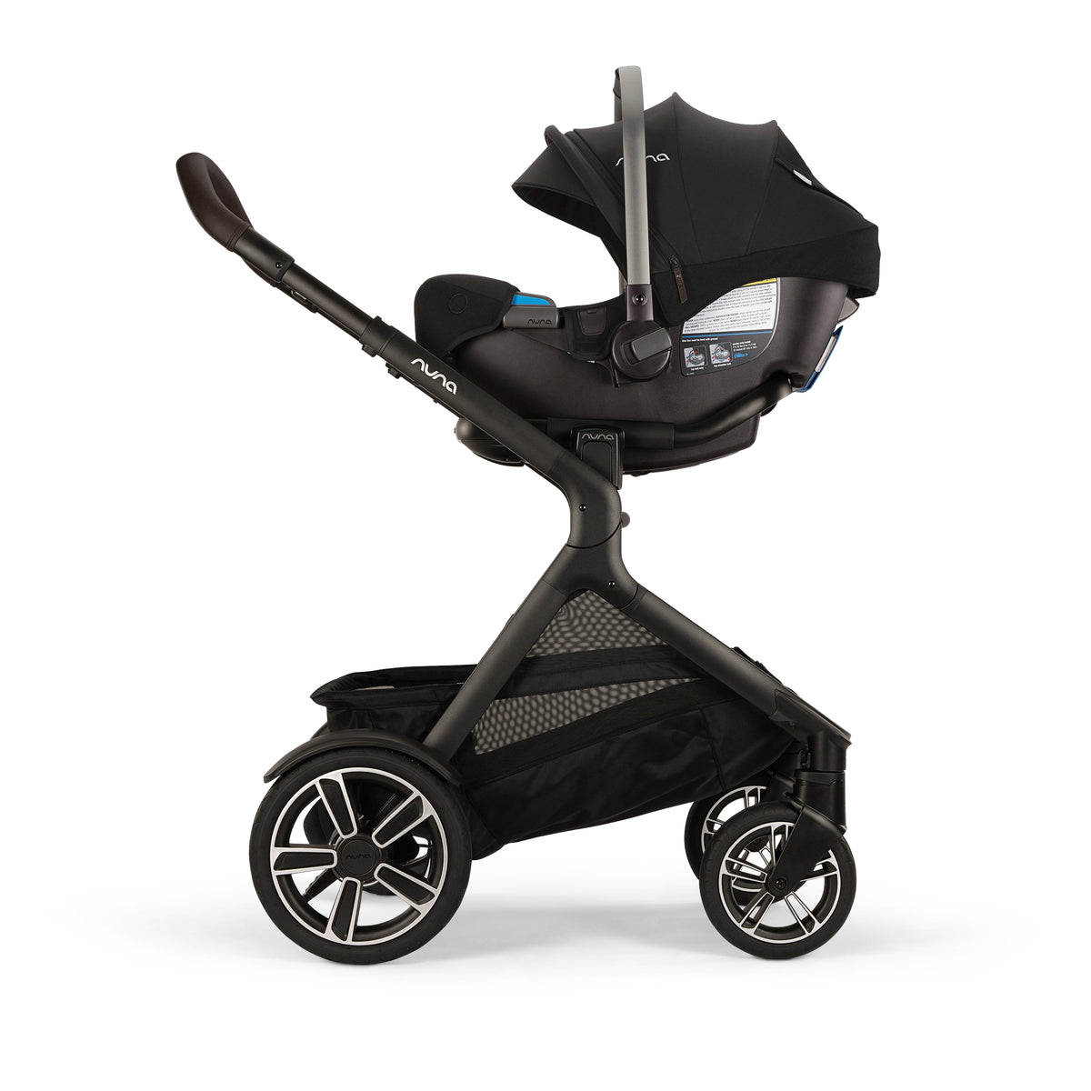 
A black and dark gray stroller with an attached infant car seat and canopy, shown from a side profile on a clean white background. The stroller features a large storage basket underneath and multi-spoke wheels.