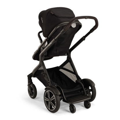 
Nuna Demi Next Stroller shown from a three quarter turn to show the Rider Board that's included with Demi Next for an older child to ride along their younger sibling.