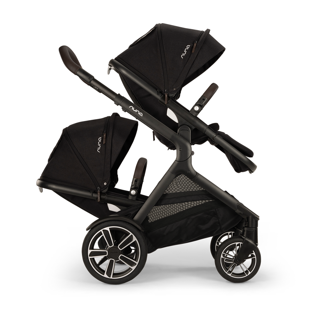 
Side profile of a double black stroller configured with two facing seats and extended canopies, isolated on a transparent background.