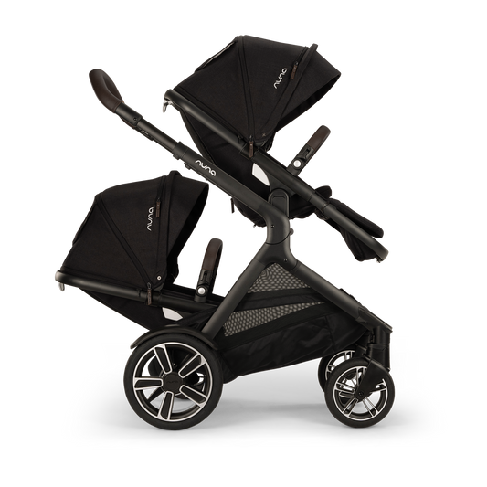 [Chocolate Caviar] Side profile of a double black stroller configured with two facing seats and extended canopies, isolated on a transparent background.