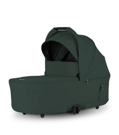 Silver Cross Nia bassinet dark green conifer featuring a protective canopy, carry handle, and spacious newborn carrycot design for stroller travel systems.