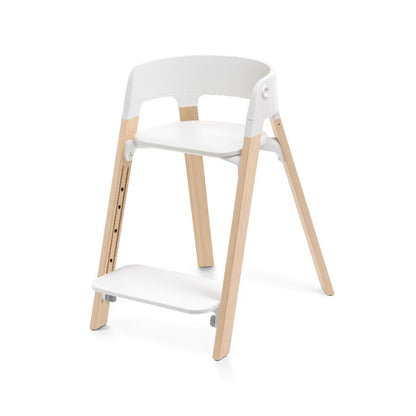
A modern step stool chair with a white molded plastic seat, backrest, and footrest, supported by four natural light wood legs, shown on a clean white background.