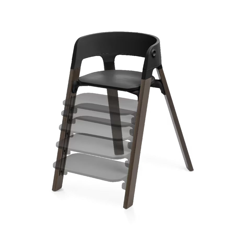 
A modern wooden dining chair with a black molded seat and backrest, shown on a clean white background. A semi-transparent layered graphic behind it illustrates additional seat heights or configurations.